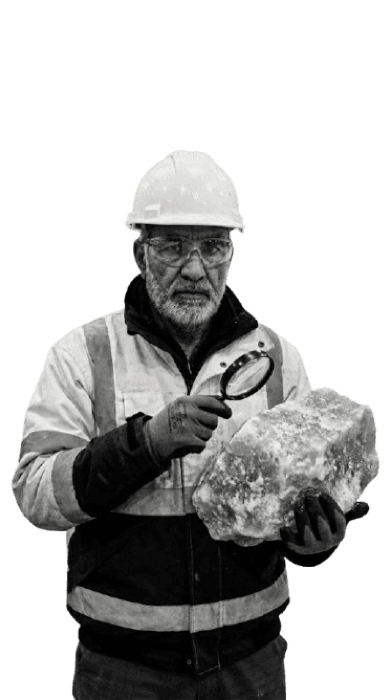 Inspector examining a salt rock with a magnifier